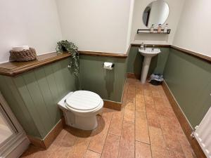 a bathroom with a toilet and a sink at True Lovers Knot, Tarrant Keyneston in Tarrant Keynston