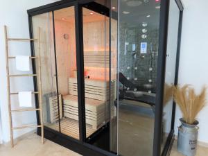 a glass cabinet with books inside of it at Le Foyer Celtique in Ploërmel
