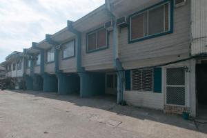 a row of buildings with blue trim on a street at G Fam Transient by RedDoorz in Manila