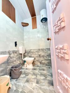 a bathroom with a toilet and a sink at SanjayHomestay in Rāmpur