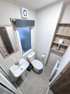 a bathroom with a white toilet and a sink at Birchington Vale - Trieste Sleeps 6 in Westgate-on-Sea +19 photos