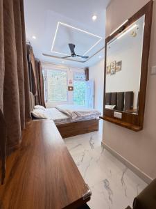a bedroom with a mirror and a bed in it at SanjayHomestay in Rāmpur +30 photos