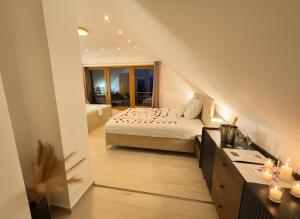 a large bedroom with a bed and a bathroom at Szent László Residence in Mátraszentimre