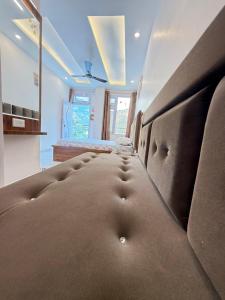 a room with a large couch in the middle at SanjayHomestay in Rāmpur