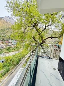 a balcony with a tree on top of a building at SanjayHomestay in Rāmpur