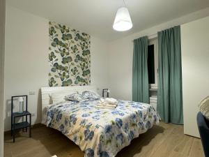 a bedroom with a bed with a blue and white comforter at Agriturismo Belfiore in Castelnuovo Magra