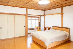 a bedroom with a bed and a guitar in it at Mountain Home - One Hour From Osaka in Uda