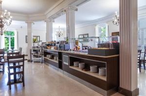a restaurant with a counter with plates on it at Hotel Mediodia in Madrid