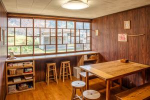 a kitchen with a table and a bar with stools at Mountain Home - One Hour From Osaka in Uda