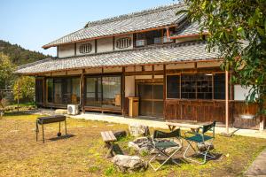 a house with a group of chairs in front of it at Mountain Home - One Hour From Osaka in Uda +20 photos