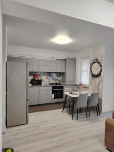 a kitchen and dining room with a table and chairs at Panorama Loft in Gura Humorului