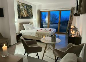 a bedroom with a bed and a table and chairs at Szent László Residence in Mátraszentimre