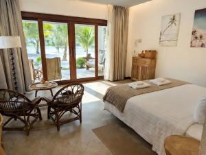 a bedroom with a bed and a table and chairs at Mint Lotus Resort - Koh Kood in Ban Bang Bao