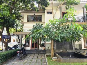a motorcycle parked in front of a building at Casa Palma by Ezzego in Bandung
