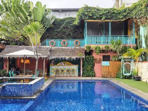 a house with a swimming pool in front of a building at Casa Palma by Ezzego in Bandung