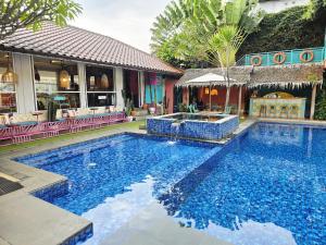 a large swimming pool in front of a building at Casa Palma by Ezzego in Bandung