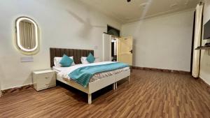 a bedroom with a bed and a mirror on the wall at Hotel Divine in Faridabad
