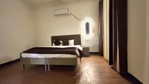 a bedroom with a bed in a room at Hotel Divine in Faridabad