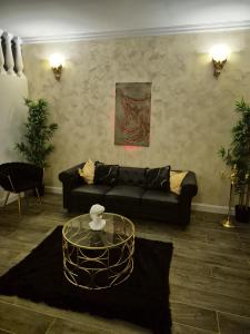 a living room with a couch and a table at Shiny Cloud Love Room in Limoux