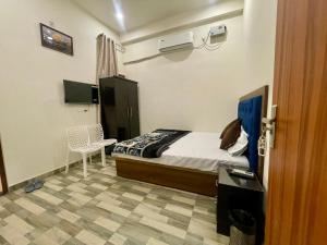 a bedroom with a bed and a table and a desk at Hotel Pilgrrim in Varanasi +36 photos
