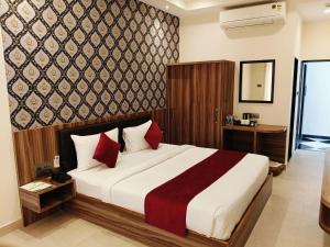 a bedroom with a large bed with red pillows at The Parmatma Hotel in Udaipur +30 photos