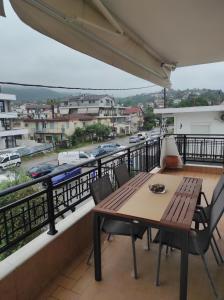 a balcony with a table and chairs and a view of a city at Stefania's Luxury House in Platamonas