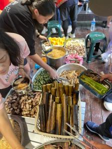 a group of people preparing food at a buffet at Tanapavana閒雲居 in Alishan +26 photos
