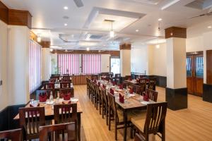 a restaurant with tables and chairs in a room at The Parmatma Hotel in Udaipur