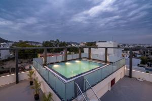a balcony with a swimming pool on top of a building at The Parmatma Hotel in Udaipur