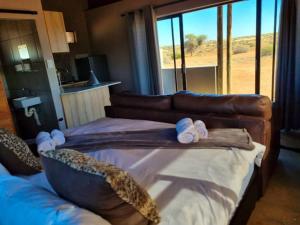 a living room with a couch and a large window at Tented Camp in Augrabies in Kakamas