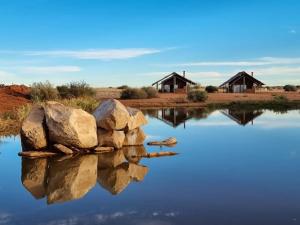 a reflection of rocks in a body of water at Tented Camp in Augrabies in Kakamas