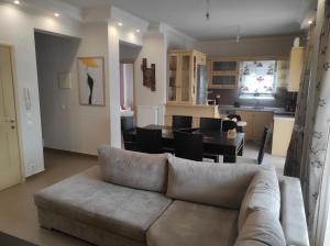 a living room with a couch and a dining room at Stefania's Luxury House in Platamonas