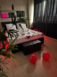 a bedroom with a bed with red balls on the floor at Altitude 24 Panorama and Spa in Mulhouse +42 photos