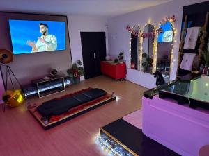 a living room with a flat screen tv on the wall at Altitude 24 Panorama and Spa in Mulhouse