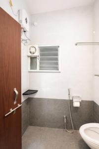 a bathroom with a toilet and a sink at LaBelle Haven Aesthetic Cozy 2BHK For Family and Couples in Indore