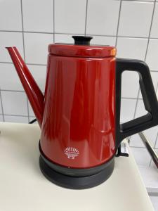 a red tea pot sitting on top of a counter at Mapo Panorama Stay in Seoul