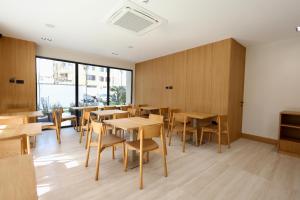 a dining room with wooden tables and chairs at Hotel Tutti in Durrës