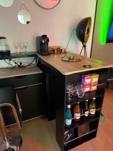 a kitchen with a counter with drinks on it at Altitude 24 Panorama and Spa in Mulhouse