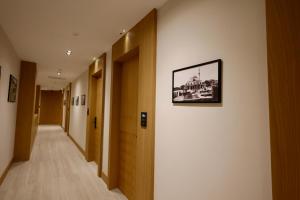 a hallway in a building with a picture on the wall at Hotel Tutti in Durrës