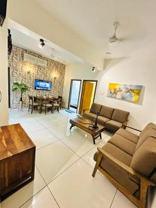 a living room with a couch and a table at LaBelle Haven Aesthetic Cozy 2BHK For Family and Couples in Indore