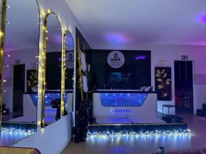 a room with a tub with lights on the floor at Altitude 24 Panorama and Spa in Mulhouse