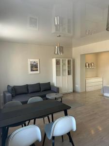 a living room with a couch and a table and chairs at Studio flat Centrinis Butukas in Kėdainiai