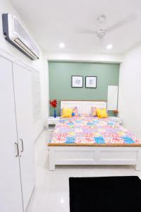 a bedroom with a large bed with yellow pillows at LaBelle Haven Aesthetic Cozy 2BHK For Family and Couples in Indore