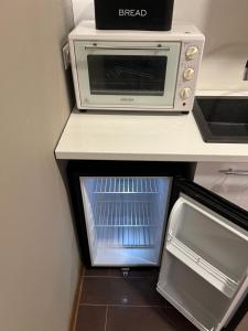 a toaster oven sitting on top of a counter at Ludza Comfort Apartment in Ludza +32 photos