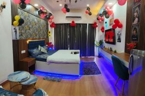 a room with a bed and balloons in it at Caelume Luxury Studios in Ghaziabad