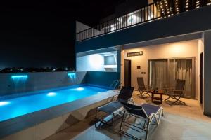 a swimming pool in the middle of a building at night at Shriji Ananda Hotel & Resort in Dhār