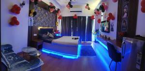 a room with a bed with blue lights in it at Caelume Luxury Studios in Ghaziabad