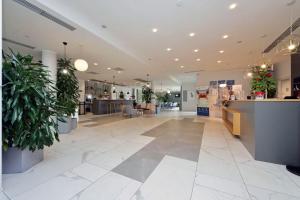 a lobby of a store with potted plants at Quarto Verde in Bergamo +117 photos