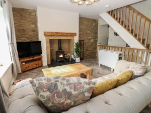 a living room with a couch and a television at 2 Low Road in Bishop Auckland