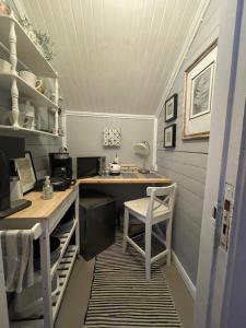 a small room with a desk and a table and chairs at Granbo station in Granbo +20 photos